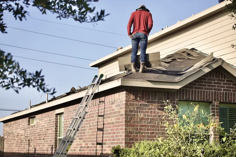 Professional roofer working on a residential roof in New Morgan